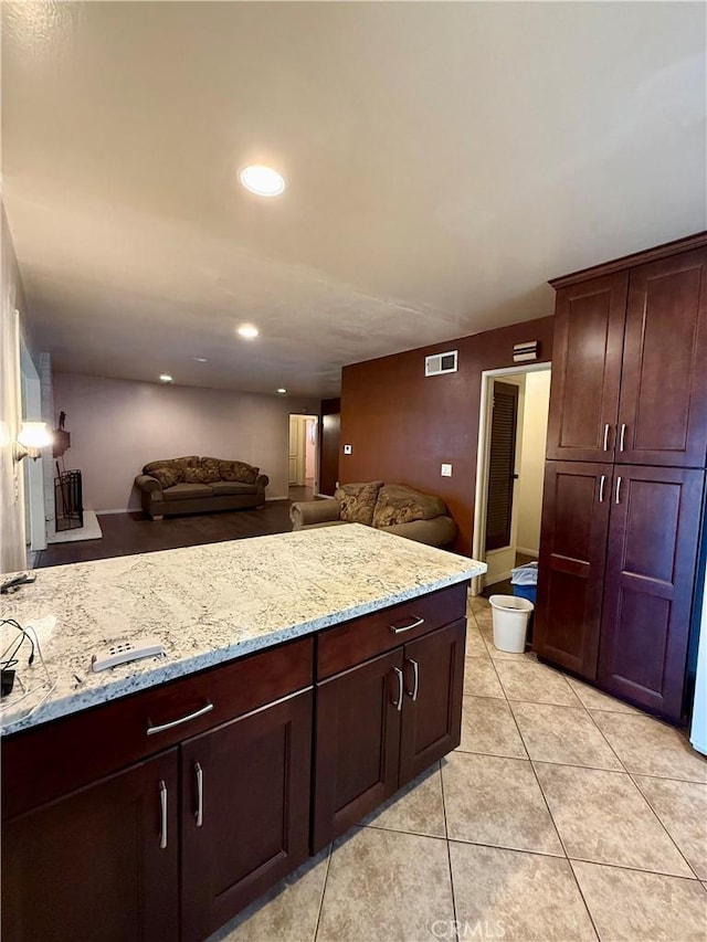 14120 Dillerdale St, La Puente, CA 91746 - kitchen featuring light stone counters, open floor plan, light tile patterned floors, recessed lighting, and dark brown cabinets