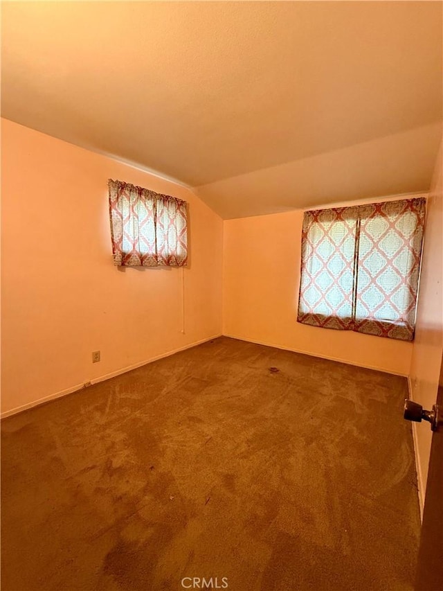 14120 Dillerdale St, La Puente, CA 91746 - unfurnished room featuring vaulted ceiling and dark colored carpet