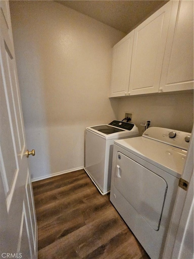 30375 June Rose Ct, Castaic, CA 91384 - laundry area featuring independent washer and dryer, cabinet space, dark wood-style flooring, and baseboards