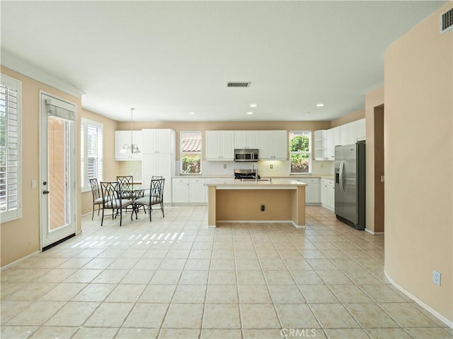 30375 June Rose Ct, Castaic, CA 91384 - kitchen featuring stainless steel appliances, light countertops, a sink, an island with sink, and white cabinets