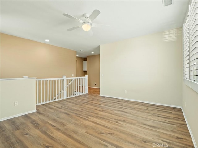 30375 June Rose Ct, Castaic, CA 91384 - empty room featuring a ceiling fan, wood finished floors, baseboards, and recessed lighting
