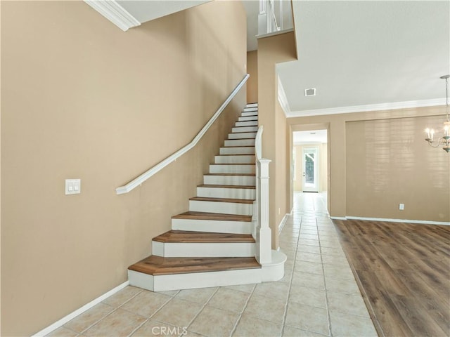30375 June Rose Ct, Castaic, CA 91384 - stairway featuring ornamental molding, tile patterned floors, baseboards, and a chandelier