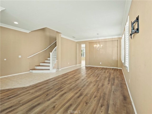 30375 June Rose Ct, Castaic, CA 91384 - unfurnished living room with a chandelier, stairs, wood finished floors, ornamental molding, and baseboards