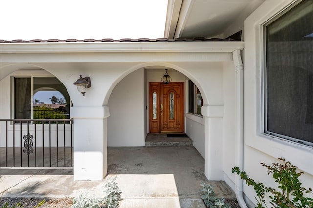 view of exterior entry with covered porch