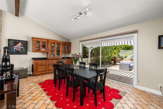 dining room with plenty of natural light, brick floors, and baseboards