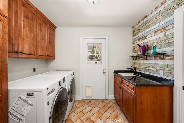 washroom with cabinet space, washer and clothes dryer, and baseboards