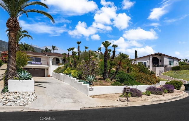 mediterranean / spanish-style house with driveway, an attached garage, and stucco siding