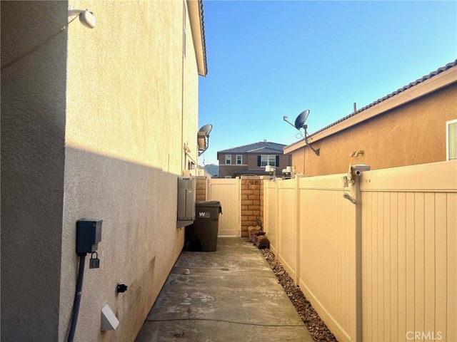 view of home's exterior with stucco siding and fence