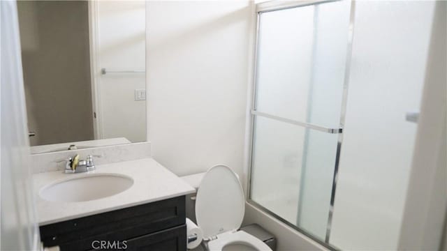 bathroom with vanity, toilet, and enclosed tub / shower combo