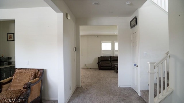 corridor featuring light colored carpet