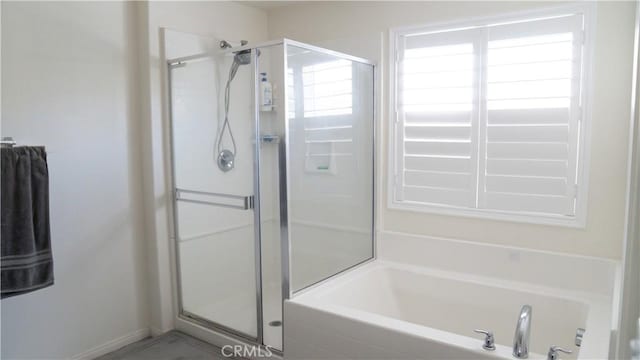 bathroom with a stall shower and a bath