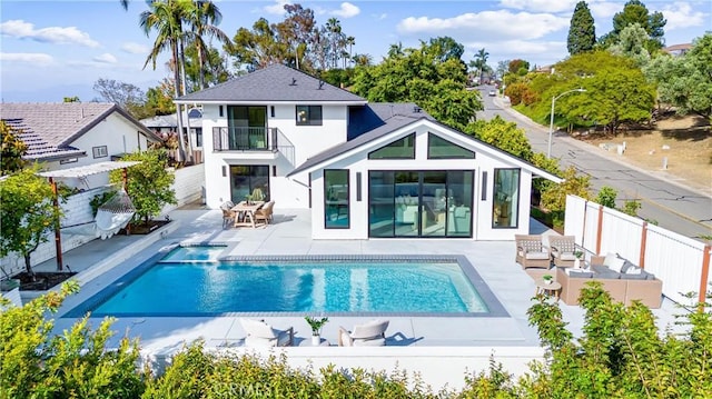 29951 Morongo Pl, Laguna Niguel, CA 92677 - rear view of property featuring a balcony, a patio, stucco siding, a pool with connected hot tub, and outdoor lounge area