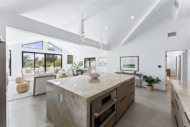 29951 Morongo Pl, Laguna Niguel, CA 92677 - kitchen with modern cabinets, open floor plan, concrete flooring, high vaulted ceiling, and a center island