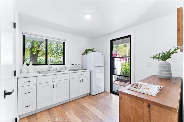 29951 Morongo Pl, Laguna Niguel, CA 92677 - kitchen with freestanding refrigerator, a sink, healthy amount of natural light, and light wood finished floors