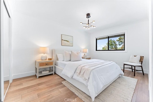 29951 Morongo Pl, Laguna Niguel, CA 92677 - bedroom featuring light wood-style flooring, a chandelier, and baseboards