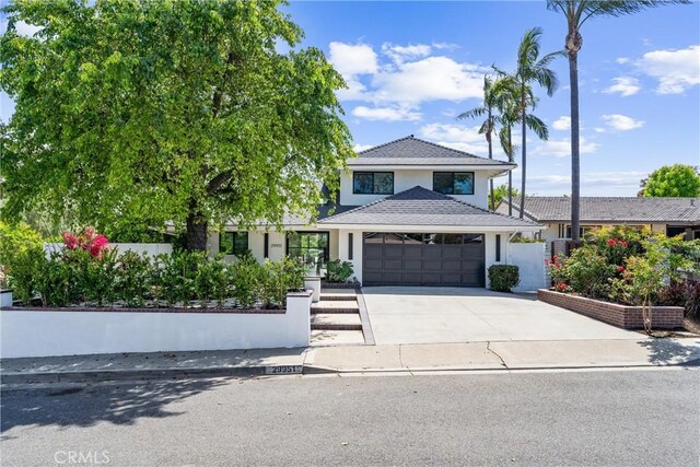 29951 Morongo Pl, Laguna Niguel, CA 92677 - view of front facade with concrete driveway, a garage, and stucco siding