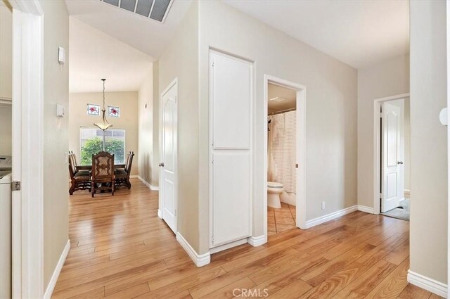 22523 White Sage St, Corona, CA 92883 - corridor featuring light wood finished floors, lofted ceiling, and baseboards