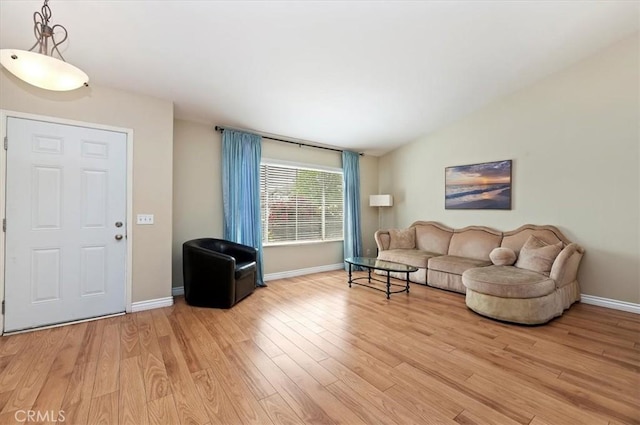 22523 White Sage St, Corona, CA 92883 - living room featuring light wood-style flooring, lofted ceiling, and baseboards