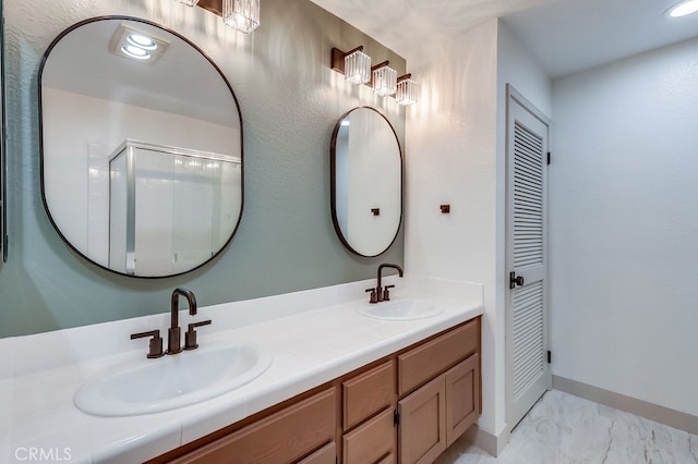 full bath with marble finish floors, double vanity, an enclosed shower, and baseboards