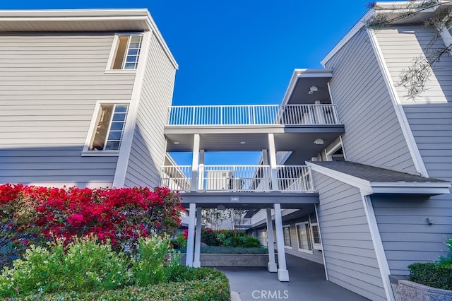 back of property featuring a balcony