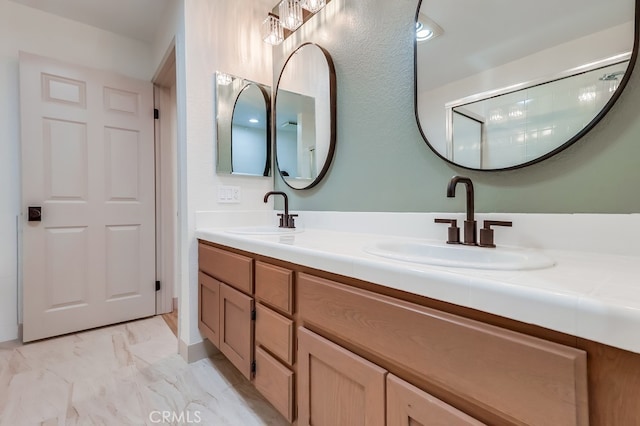 bathroom with marble finish flooring and double vanity
