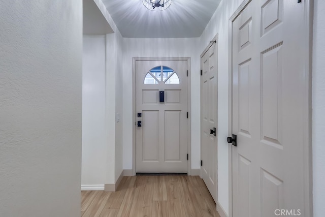 entryway with light wood-type flooring and baseboards