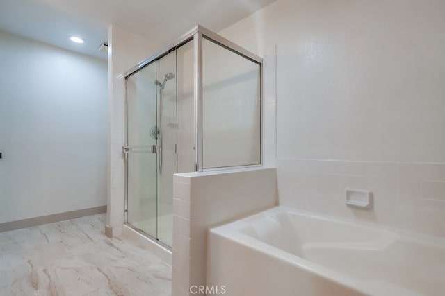 full bath featuring a stall shower, a bath, and marble look tile flooring