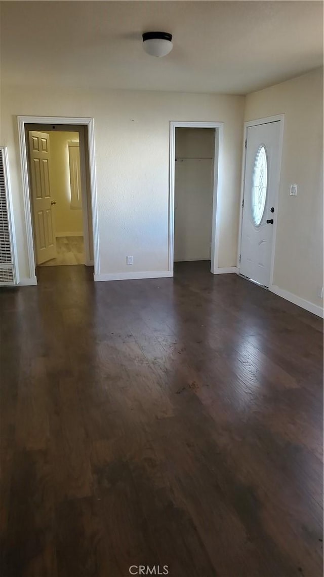 44709 6th St E, Lancaster, CA 93535 - entrance foyer with a heating unit, baseboards, and dark wood-type flooring
