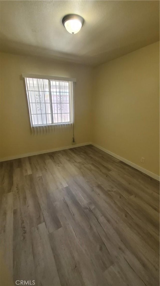 44709 6th St E, Lancaster, CA 93535 - spare room featuring wood finished floors and baseboards