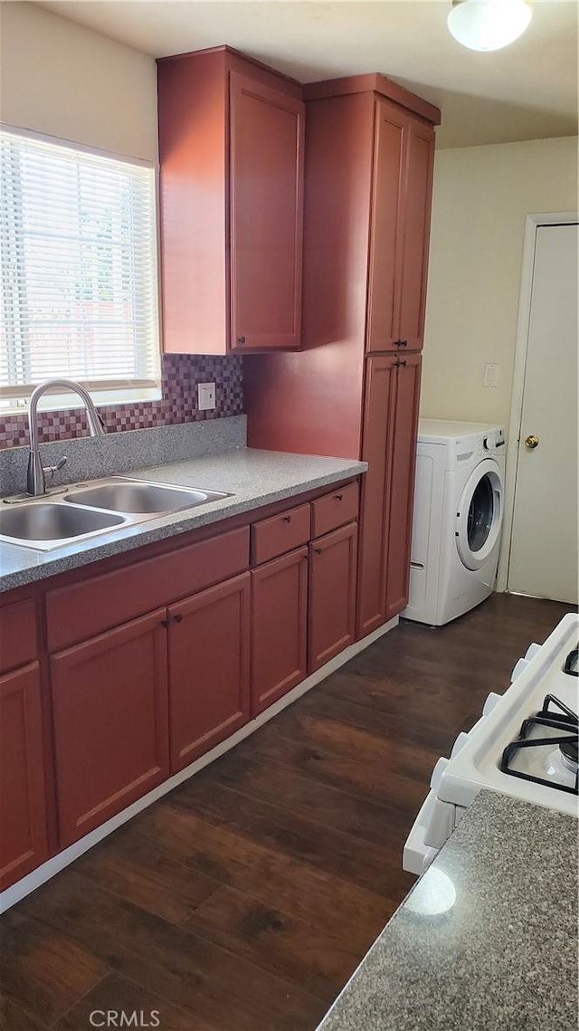 44709 6th St E, Lancaster, CA 93535 - kitchen with a sink, washer / dryer, dark wood-style flooring, and backsplash