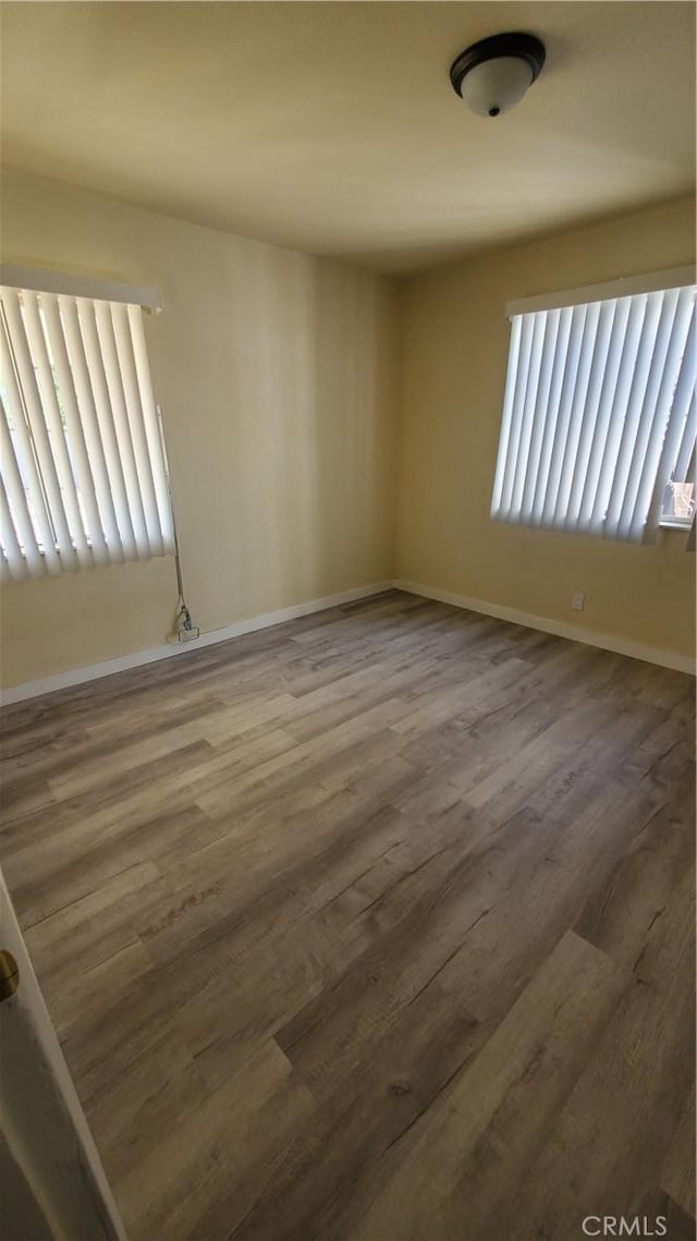 44709 6th St E, Lancaster, CA 93535 - empty room with wood finished floors and baseboards
