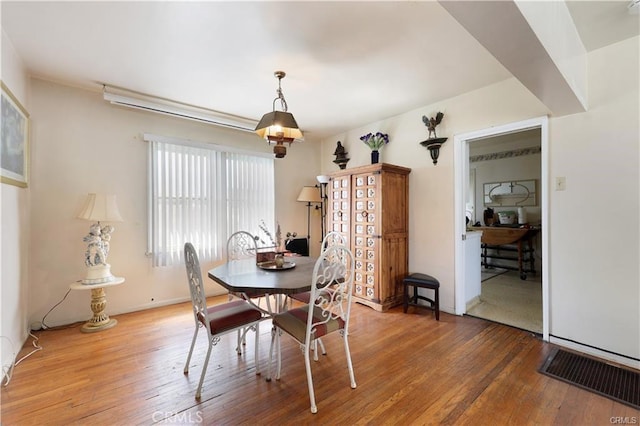dining room featuring wood-type flooring and baseboards