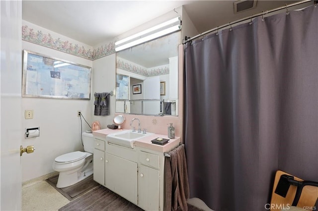 full bathroom with toilet and vanity