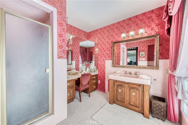 full bath with a stall shower, wallpapered walls, and vanity