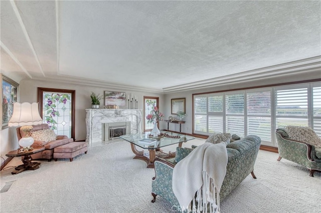 living room featuring carpet floors, a textured ceiling, and a fireplace