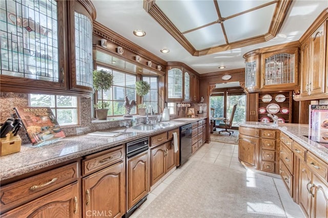 kitchen with a sink, black dishwasher, decorative backsplash, glass insert cabinets, and ornamental molding
