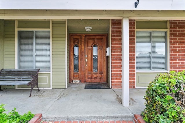 20672 Chaucer Ln, Huntington Beach, CA 92646 - view of exterior entry with brick siding and covered porch