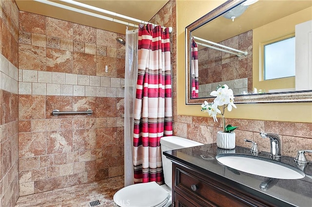 20672 Chaucer Ln, Huntington Beach, CA 92646 - bathroom featuring a tile shower, tile walls, vanity, and toilet