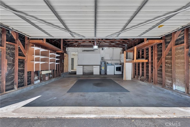 garage with washing machine and clothes dryer and a garage door opener