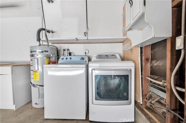 washroom featuring washer and clothes dryer and strapped water heater