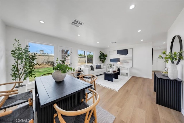 dining space featuring light wood finished floors and recessed lighting