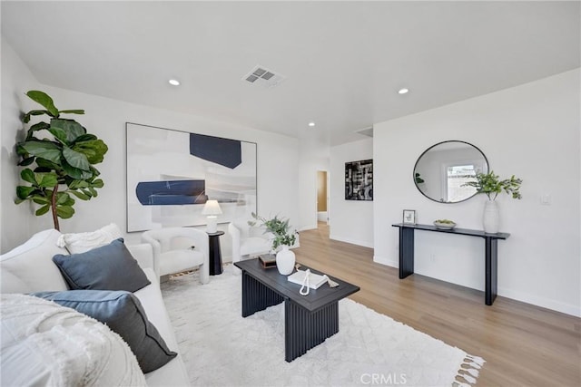 living area featuring wood finished floors, recessed lighting, and baseboards