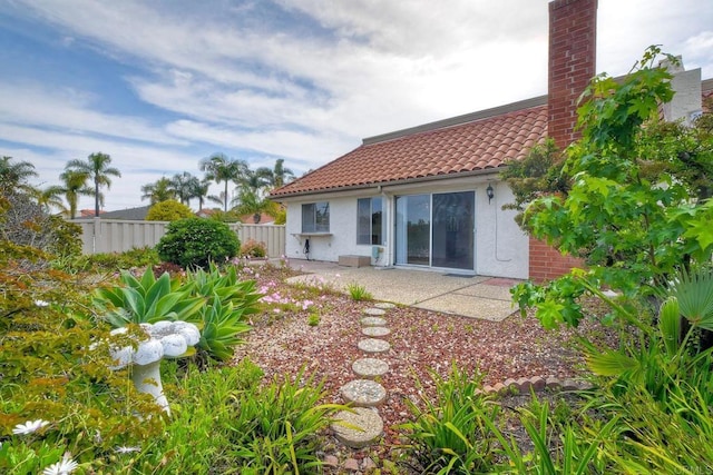 3579 Twilight Ln, Oceanside, CA 92056 - back of house with a tile roof, fence, stucco siding, and a chimney