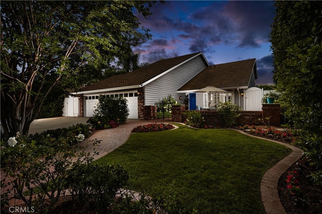 18672 Evergreen Ave, Yorba Linda, CA 92886 - property exterior at dusk with driveway, a garage, and a lawn