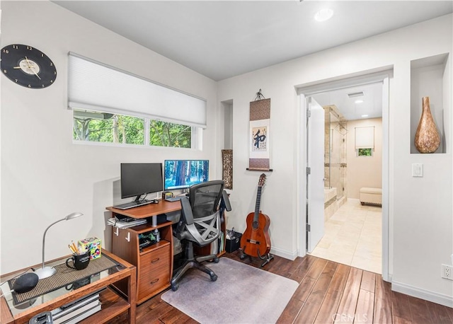 office area with wood finished floors and baseboards