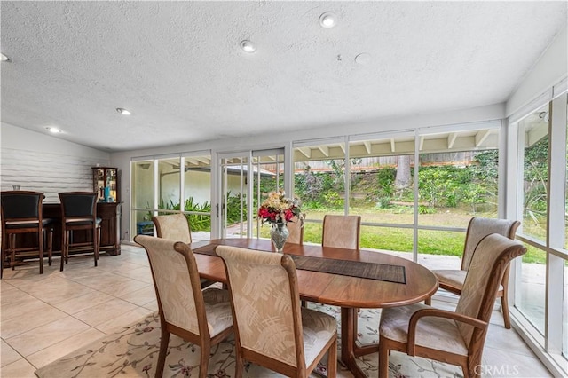 sunroom with a textured ceiling, tile patterned flooring, and recessed lighting
