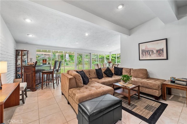 living room featuring healthy amount of natural light, light tile patterned floors, recessed lighting, and a textured ceiling