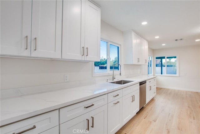 14704 Germain St, Mission Hills San Fernando, CA 91345 - kitchen featuring a sink, white cabinetry, light wood-type flooring, dishwasher, and light stone counters