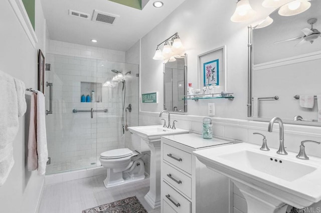 full bathroom with a stall shower, a sink, toilet, tile patterned flooring, and recessed lighting