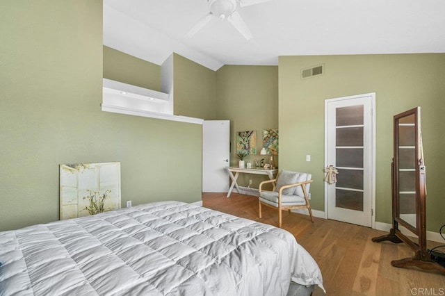 bedroom featuring wood finished floors, high vaulted ceiling, and a ceiling fan